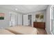 Main bedroom features laminate floors and access to a bathroom, closets and other rooms at 4905 Pall Mall E St, Kissimmee, FL 34758