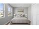 Cozy main bedroom featuring a comfortable bed, plush rug, and a view to the outside at 4905 Pall Mall E St, Kissimmee, FL 34758