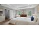Main bedroom with wood floors, a tray ceiling, and three windows at 4905 Pall Mall E St, Kissimmee, FL 34758