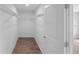 Walk-in closet with wire shelving and wood floor at 4905 Pall Mall E St, Kissimmee, FL 34758