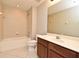 This full bathroom has a vanity with a sink, toilet, bathtub, shower, and tiled walls at 506 Harbor Winds Ct, Winter Springs, FL 32708