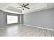 This bedroom features high ceilings, a ceiling fan, gray walls, and light colored floors that add to its overall appeal at 506 Harbor Winds Ct, Winter Springs, FL 32708