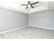 The gray walls of this bedroom are complemented by gray flooring and stylish ceiling fan at 506 Harbor Winds Ct, Winter Springs, FL 32708