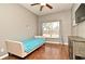 This bedroom features hardwood floors, neutral walls, a ceiling fan, and a sun-filled window at 506 Harbor Winds Ct, Winter Springs, FL 32708