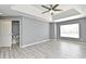 Bright bedroom features an open window, ceiling fan, spacious gray walls and a door to a walk-in closet at 506 Harbor Winds Ct, Winter Springs, FL 32708