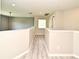 This hallway features gray walls, light wood floors, recessed lighting, and white railings at 506 Harbor Winds Ct, Winter Springs, FL 32708