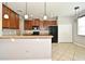 Well-equipped kitchen with wood cabinets, granite counters, and stainless steel appliances at 506 Harbor Winds Ct, Winter Springs, FL 32708