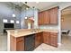 Open-concept kitchen featuring a breakfast bar, modern lighting, and wood cabinetry at 506 Harbor Winds Ct, Winter Springs, FL 32708