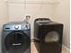 This laundry room features a gray front load washer and dark gray front load dryer at 506 Harbor Winds Ct, Winter Springs, FL 32708