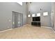 Bright living room with high ceilings, tan tile flooring, and a modern entertainment center at 506 Harbor Winds Ct, Winter Springs, FL 32708