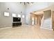Open-concept living room with tile floors, staircase, and natural light at 506 Harbor Winds Ct, Winter Springs, FL 32708