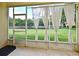 Screened patio overlooking a grassy backyard and pond, perfect for relaxation at 506 Harbor Winds Ct, Winter Springs, FL 32708