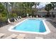 Community pool surrounded by lounge chairs and lush landscaping at 506 Harbor Winds Ct, Winter Springs, FL 32708