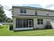 View of the house with a screened in patio area and trimmed hedges set in a manicured green lawn at 506 Harbor Winds Ct, Winter Springs, FL 32708