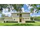 Back view of the house showing the back entrance, several windows, and well maintained landscaping at 506 Harbor Winds Ct, Winter Springs, FL 32708