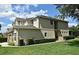The side of the house with a well-manicured green lawn, lush shrubs, and access to the front and rear at 506 Harbor Winds Ct, Winter Springs, FL 32708