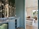 Sophisticated bar with marble countertop, open shelving, and seamless flow into the living area at 541 W Canton Ave, Winter Park, FL 32789