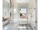 Bright bathroom featuring marble vanity, freestanding tub, and a seamless glass shower enclosure at 541 W Canton Ave, Winter Park, FL 32789