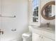 Charming bathroom with a window, white cabinets, and decorative fixtures at 541 W Canton Ave, Winter Park, FL 32789