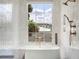 Bright bathroom features white tile and a large window over a soaking tub at 541 W Canton Ave, Winter Park, FL 32789