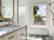 Bright bathroom features white tile, a soaking tub, and a double shower head at 541 W Canton Ave, Winter Park, FL 32789