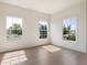 Well-lit bedroom with hardwood floors and three large windows at 541 W Canton Ave, Winter Park, FL 32789