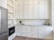 This white butler's pantry includes custom cabinets, counter space and storage at 541 W Canton Ave, Winter Park, FL 32789