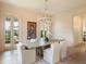 Elegant dining room with modern chandelier, farm table, and glass doors to the outside at 541 W Canton Ave, Winter Park, FL 32789
