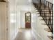 Bright hallway featuring decorative wood wall panels, wooden floor, and metal staircase at 541 W Canton Ave, Winter Park, FL 32789