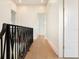 Bright hallway featuring hardwood floors, decorative railing, and crisp white trim at 541 W Canton Ave, Winter Park, FL 32789