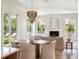 Spacious living area with fireplace, modern lighting, neutral colors, and large windows overlooking pool at 541 W Canton Ave, Winter Park, FL 32789