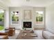 Living room featuring a fireplace, an oversized coffee table and two large windows at 541 W Canton Ave, Winter Park, FL 32789