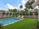 Relaxing backyard pool area with lounge chairs and lush artificial grass at 541 W Canton Ave, Winter Park, FL 32789