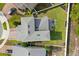 Aerial view of the home showcasing the roof, backyard with patio set, and surrounding neighborhood at 5458 Carrara Ct, St Cloud, FL 34771