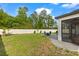 Fenced backyard features a paved patio, outdoor seating, and a lush green lawn, perfect for outdoor enjoyment at 5458 Carrara Ct, St Cloud, FL 34771