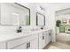 Bright bathroom featuring dual sinks, modern fixtures, and an adjacent doorway to a Bedroom at 5458 Carrara Ct, St Cloud, FL 34771