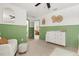 Cozy bedroom with green wainscoting, white dresser, and neutral carpet at 5458 Carrara Ct, St Cloud, FL 34771