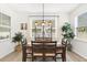 Bright dining room with large windows, wood table, and modern decor, perfect for Gathering meals at 5458 Carrara Ct, St Cloud, FL 34771