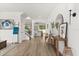 Bright entryway with wood floors, modern decor, and a staircase leading to the second floor at 5458 Carrara Ct, St Cloud, FL 34771