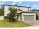 Charming two-story home features a brick driveway, neutral paint, and well-maintained landscaping at 5458 Carrara Ct, St Cloud, FL 34771
