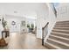 Inviting foyer with staircase, stylish decor, and ample natural light creating a welcoming entrance at 5458 Carrara Ct, St Cloud, FL 34771