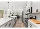 Spacious kitchen with stainless steel appliances, center island, and ample counter space for cooking at 5458 Carrara Ct, St Cloud, FL 34771