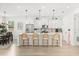 Bright, open kitchen with white cabinetry, stainless steel appliances, and a large center island with seating at 5458 Carrara Ct, St Cloud, FL 34771