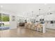 Bright kitchen with modern appliances, a large island with seating, and a dining area at 5458 Carrara Ct, St Cloud, FL 34771