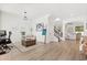 Bright living area showcasing wood floors, neutral walls, and an open layout with modern decor at 5458 Carrara Ct, St Cloud, FL 34771