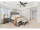 Comfortable main bedroom with neutral color palette, tray ceiling, and accent furniture at 5458 Carrara Ct, St Cloud, FL 34771