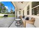 Covered patio with a wicker couch, a ceiling fan, a side table, and a grill, great for outdoor relaxation at 5458 Carrara Ct, St Cloud, FL 34771