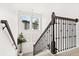 Elegant staircase with dark wood banister and decorative lighting fixture, adding architectural detail to the home at 5458 Carrara Ct, St Cloud, FL 34771