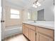 Bathroom featuring a bathtub and vanity with tile backsplash at 6042 Brookhill Cir, Orlando, FL 32810