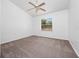 Carpeted bedroom with ceiling fan and view of the backyard at 6042 Brookhill Cir, Orlando, FL 32810